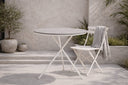 Garden table Malari - a round dining table with Aintwood tabletop and a metal frame