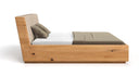 Designer wooden bed Cassian made of solid oak with storage space