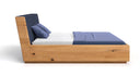 Designer wooden bed Cassian made of solid oak with storage space