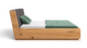 Designer wooden bed Cassian made of solid oak with storage space