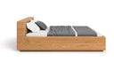 Designer wooden bed Calveno made of solid Oak with storage and straight headboard