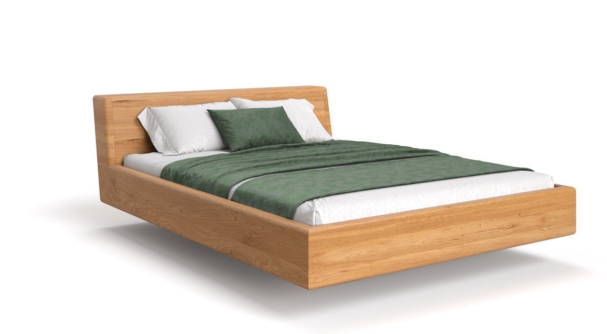 Designer wooden bed Arvelo made of solid Oak with floating appearance and slanted headboard