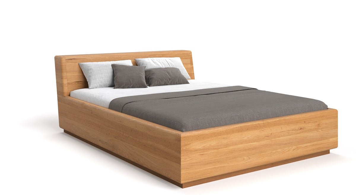 Designer wooden bed Calveno made of solid Oak with storage and slanted headboard