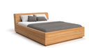 Designer wooden bed Calveno made of solid Oak with storage and slanted headboard